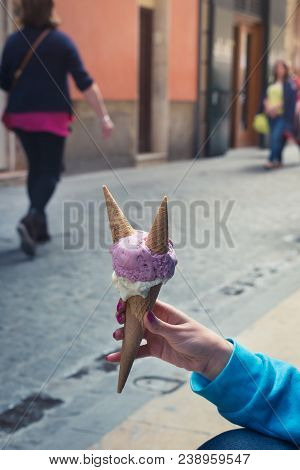 A Woman Sitting And Holding An Ice Cream. Summer Time In The Street Of The Old City
