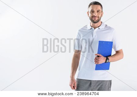 Portrait Of Smiling Rehabilitation Therapist With Notepad Isolated On Grey