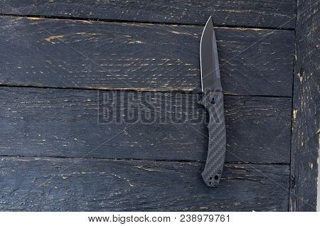 Switchblade Knife. Black Knife On A Black Background.