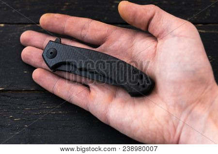 Pocket Knife In Folded Form In Hand.
