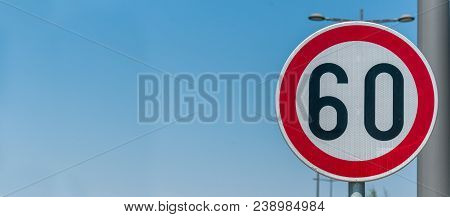Traffic Speed Limit Sign For Restriction On 60 Kilometers Or Miles Per Hour With Blue Sky Background