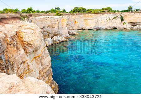 Crystal Clear Water On Torre Sant Andrea Beach With Its Jagged Coast Landscape. Ionian Sea Bay In Me