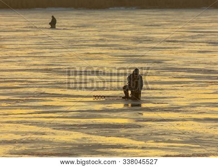 Lipetsk, Russia - December 6, 2019: A Man Catches Fish On Ice In The Morning At The Matyr Reservoir.