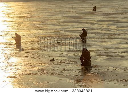 Lipetsk, Russia - December 6, 2019: Guys Catch Fish On Ice In The Morning At The Matyr Reservoir.