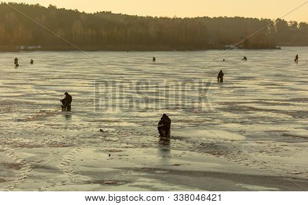 Lipetsk, Russia - December 6, 2019: Guys Catch Fish On Ice In The Morning At The Matyr Reservoir.