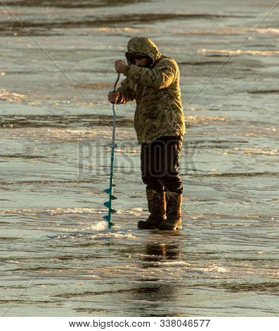 Lipetsk, Russia - December 6, 2019: A Man Catches Fish On Ice In The Morning At The Matyr Reservoir.