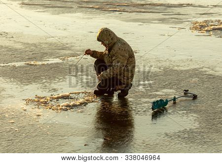 Lipetsk, Russia - December 6, 2019: A Man Catches Fish On Ice In The Morning At The Matyr Reservoir.