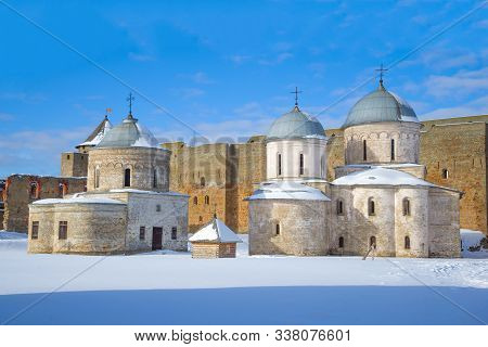 Two Ancient Orthodox Churches Close Up On A Sunny March Day. Ivangorod Fortress, Russia
