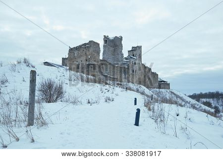 View Of The Ruins Of The Medieval Castle Of The Livonian Knights Order On A Gloomy March Day. Rakver