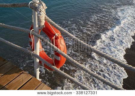 Lifebuoy With A Rope Is A Means Of Saving A Man Drowning In The Sea.