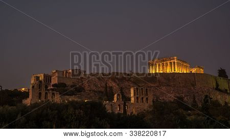 The Parthenon And Acropolis Lit Up At Night With Herodes Theater In The Foreground