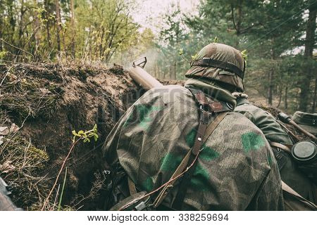 Re-enactors Dressed As German Wehrmacht Infantry Soldiers In World War Ii Sitting With Anti-tank Gre