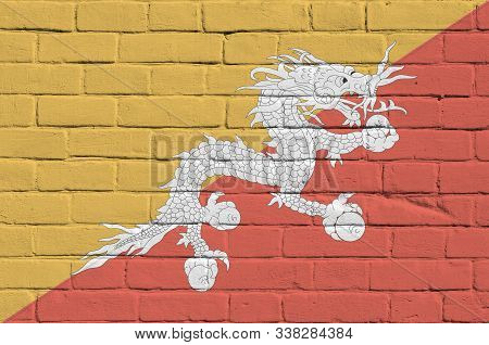 Bhutan Flag Depicted In Paint Colors On Old Brick Wall. Textured Banner On Big Brick Wall Masonry Ba