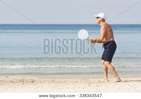 Adult Male Playing Matkot On The Beach