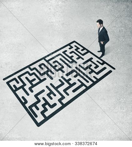 Businessman Looking On Drawing Labirinth. Success And Startup Concept.