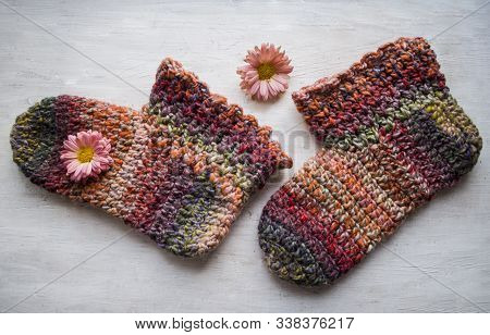 Crochet Cozy Comfortable Slippers. Photo Home Shoes On A Light Background ..