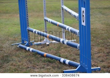 Image Of Show Jumping Poles On Empty Training Field. Wooden Barriers For Jumping Horses As A Backgro