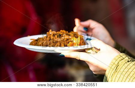 Hand Holding A Romanian Traditional Dish At The Winter Christmas Market In Bucharest.