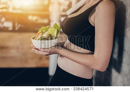 Beautiful Young Lady With Salad In The Gym. Sport Women Exercise With Healthy Food. Mental Health An