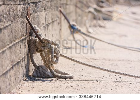 Mooring Ropes Holding Fisherman Boats In Port Of Nessebar, Bulgaria. Close Up Of Old Nautical Rope K