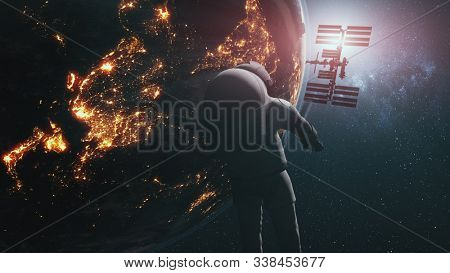 Realistic astronaut ISS revolving above Earth. Planet orbit illuminated continent. International Space Station starlight galaxy background. 3d animation. Elements of this media furnished by NASA.