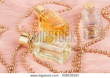Limassol, Cyprus - August 1, 2019 - Three Bottles Of Ex Nihilo Perfume And Beads On Pink Fur Backgro