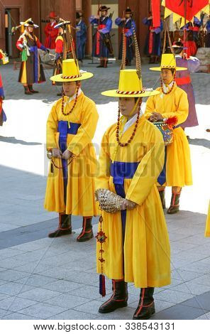 Seoul, March - 2019: Guard change ceremony at the Deoksugung Royal Palace. Musicians in yellow clothes.
