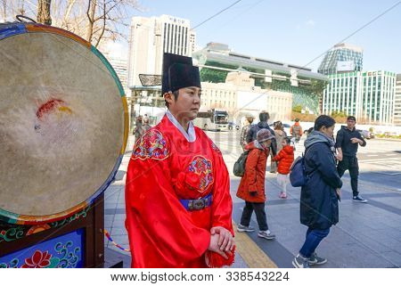Seoul, March - 2019: Guard change ceremony at the Deoksugung Royal Palace. Drummer and a large drum, view of the city hall.