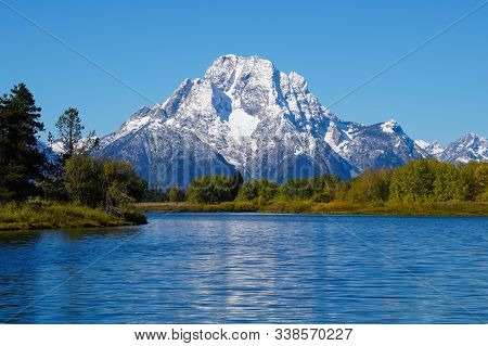 The Grand Tetons Mount Moran Rises Majestically Above The Snake River And The Forests Beautiful Autu