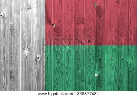 Madagascar Flag Depicted In Bright Paint Colors On Old Wooden Wall. Textured Banner On Rough Backgro