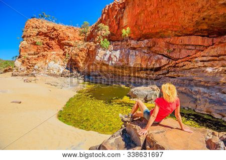 Backpacker Woman Resting After Ormiston Pound Walk, A Circuit That Follows The Rocky Slope Into Of P