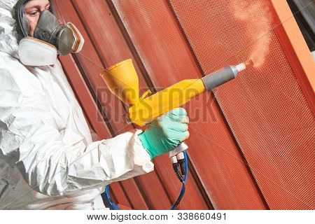 polymer coating of metal detail with powder spraying gun