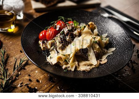 Black Angus pappardelle pasta with beef, champignon and parmegano cheese