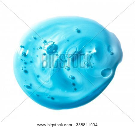 Squeezed cosmetic clear cream gel texture Iisolated on white background. Close up photo of transparent drop of skin care product. High Quality transparent gel serum with bubbles on white background