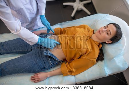 Female Patient Laying On A Couch In The Doctors Office