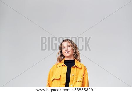Studio Portrait Of Positive Happy Young Woman Smiling Off Camera