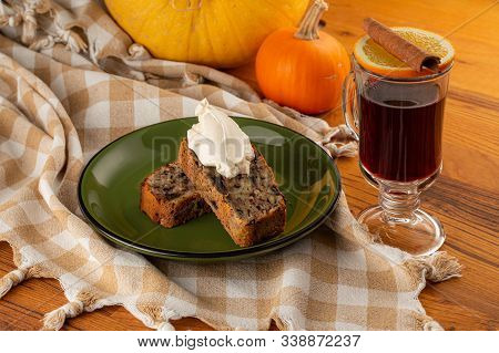 Cream On Banana Cake With Mulled Wine On A Napkin And Wooden Table