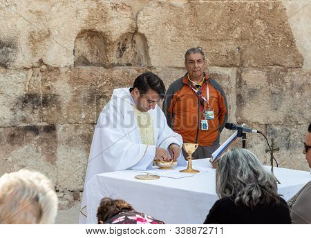 Ramla, Israel, December 07, 2019 : Priest Makes Communion At Collective Prayer On The Ruins Of A Byz