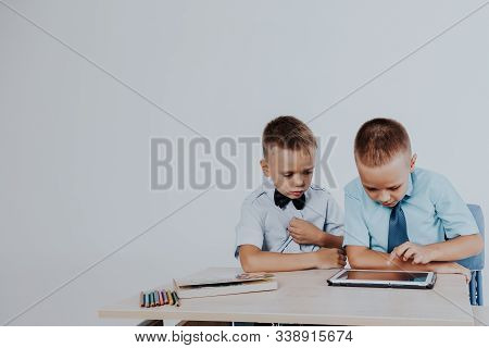 The Two Boys Are Looking At Internet Tablet School