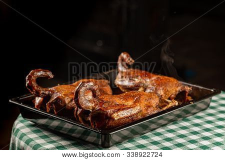 Roasted Ducks In A Cooking Tray On A Green Napkin