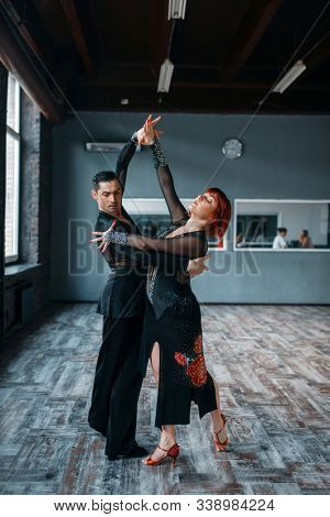 Couple on ballrom dance training in class
