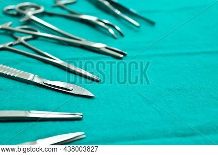 Close Up Surgical Instruments On The Green Fabric