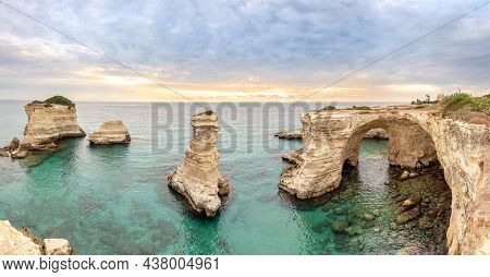 Panoramic View At The Rock Formation Faraglioni Di Saint Andrea In Torre Del Orso On The Shores Of T