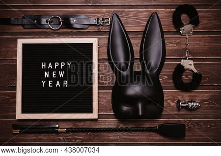 Happy New Year Written In Plastic Letters On A Letter Board. A Set Of Toys For Adults. Top View. Fla