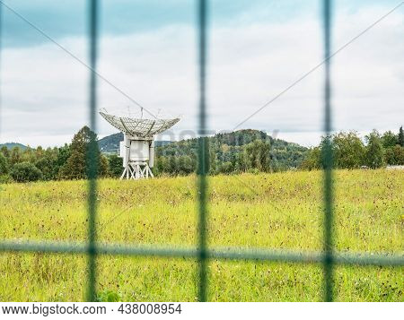 Microwave Communication Dish Behind The Fence In Secure Area. Large Dish Receivers For Satellite Com