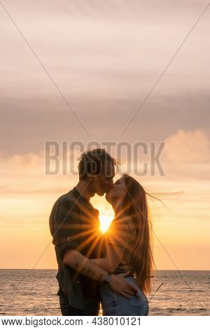 Silhouettes In Love Romantic Couple Lovers Hugging, Kissing, Touching, Eye Contact At Sunset, Sunris