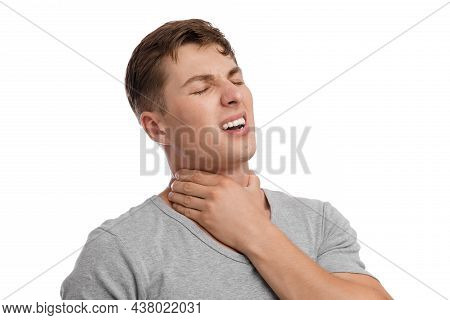 Upset Attractive Young European Guy Suffer From Sore Throat And Pressing Hand To Sore Spot, With Pai