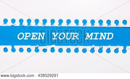 On A Blue Background With Text Open Your Mind Two White Torn Strips Of Paper.