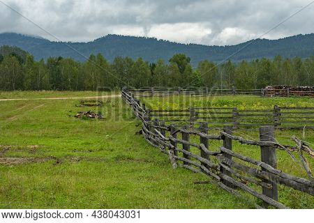 Russia. Transbaikalia, Chita Region. A Wooden Fence Made Of Boards And Poles, Which Enclose Pastures