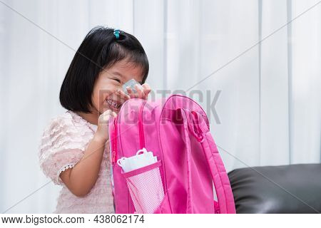 Cute Girl Laughs As She Packs Her School Bags For School At Start Of Semester So That Students Can G